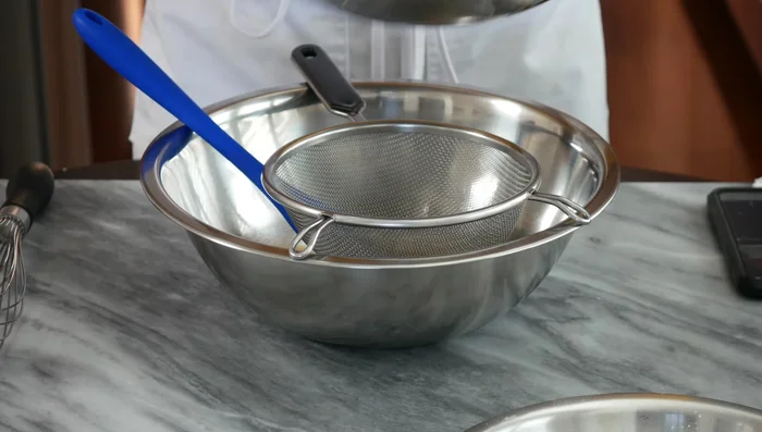 Strain the yeast mixture through a sieve to ensure a smooth batter.