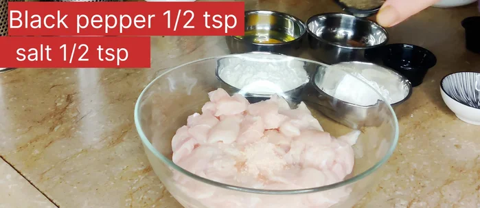 Marinate the chicken: In a bowl, combine chicken with salt, black pepper, white vinegar, soy sauce, and egg. Mix well. Add cornflour, flour, and oil. Mix thoroughly. Add water if needed to achieve a good coating consistency. Add baking powder. Let it marinate for at least 30 minutes.