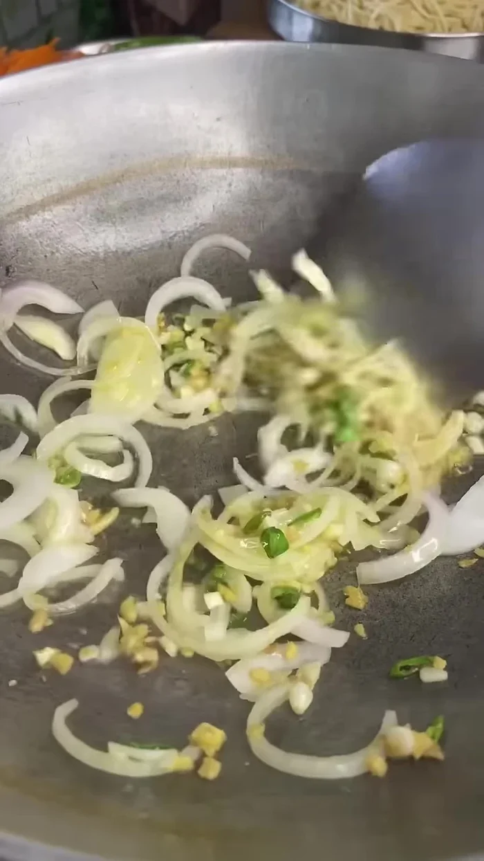 Heat oil in a pan and sauté ginger, garlic, and chili.