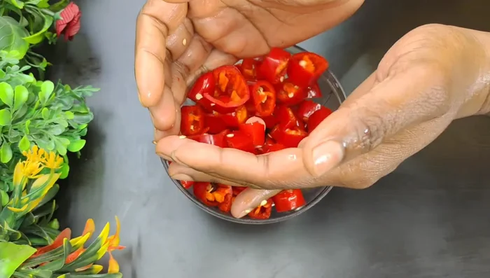 Chop the chilies, ginger, garlic, and onion using a hand chopper.