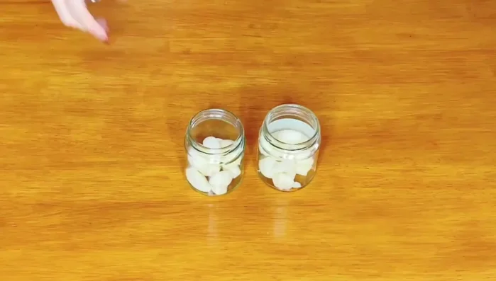 In one jar, add peeled garlic cloves and fill with white vinegar.