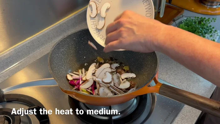 Add shiitake mushrooms, cut into thin strips, and fry until fragrant and slightly limp.
