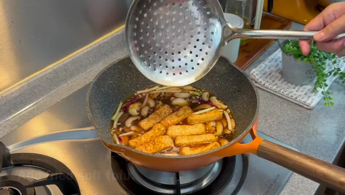Add the fried tofu to absorb the sauce. Cover and simmer for 5 minutes.