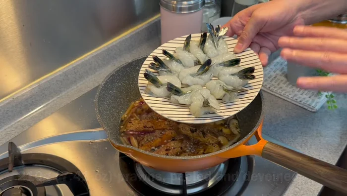 Add prawns (heads removed, tails on) and cook for 3 minutes over medium-high heat.