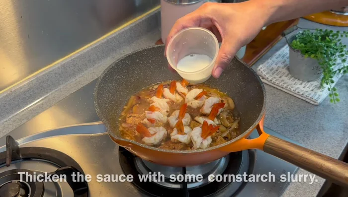 Reduce heat to medium-low. Thicken the sauce with a cornstarch or potato starch slurry.