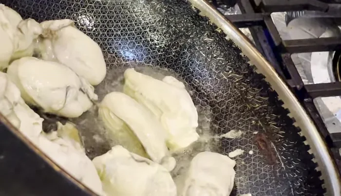 Add the blanched oysters to the sauce and cook until heated through. (Optional: Fry the oysters for a crispier texture).