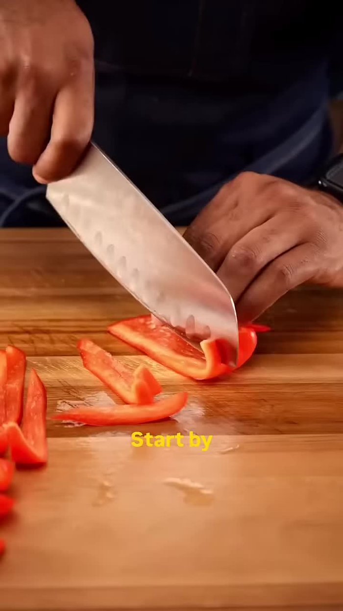 Slice a red and orange bell pepper.