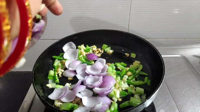 Add chopped onions and capsicum. Stir-fry for about a minute.