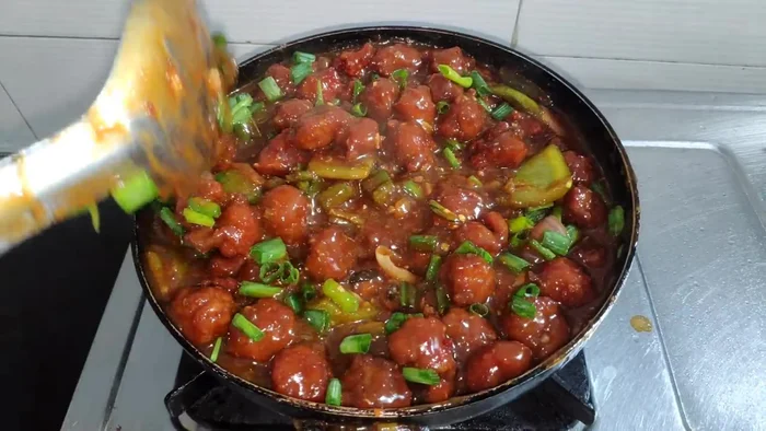 Garnish with spring onions and serve hot.