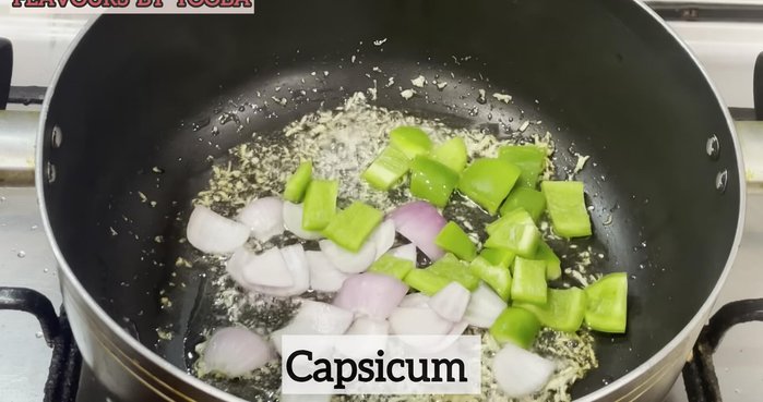 In a pan, sauté chopped garlic, onion, and capsicum. (108.479)