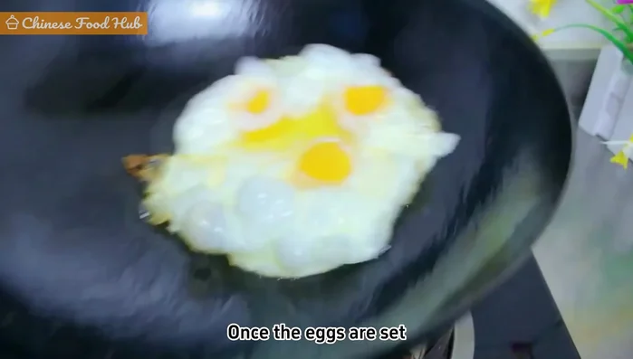 Heat oil in a pan, add beaten eggs, and cook until set. Flip and cook until both sides are golden brown. Slice into strips.