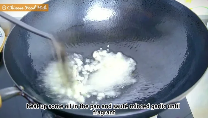 Heat oil in a pan, sauté minced garlic until fragrant. Add bean paste and stir-fry until aromatic.