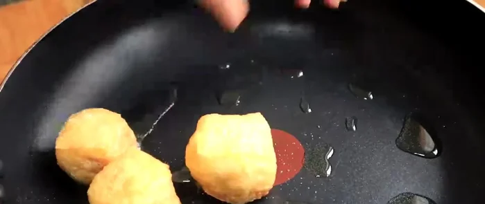 Carefully fry the stuffed tofu puffs until golden brown and cooked through. Note the cooking time and adjust heat as needed