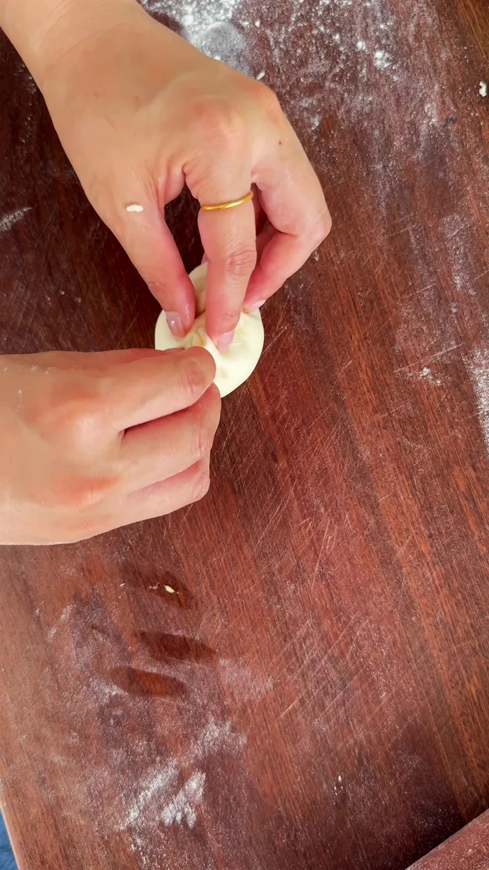 Fill each dough ball with the custard filling.