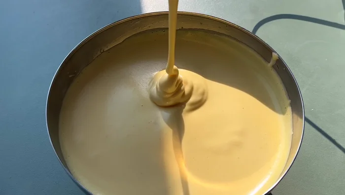 Pour the batter into the preheated baking pan.