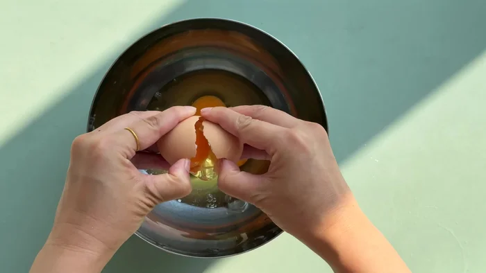 Prepare the batter by mixing flour, eggs, water, oil and salt. Add green onions if desired.