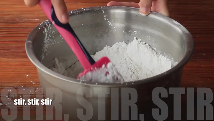 Let the batter rest for about 15-20 minutes to allow the yeast to activate. (Note: This time is an estimation, not from the transcript.)