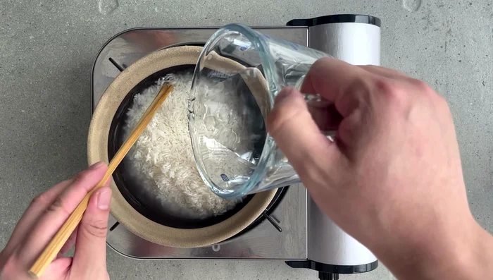 Return the chicken and sausage to the pot, adding them on top of the rice.