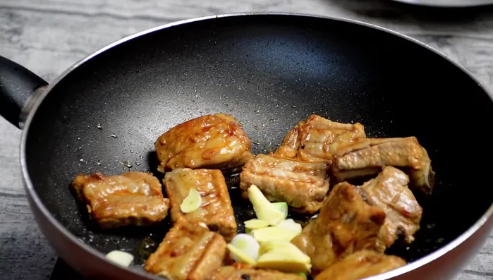 Garnish and serve: Garnish with chopped green onions and serve hot with steamed rice.