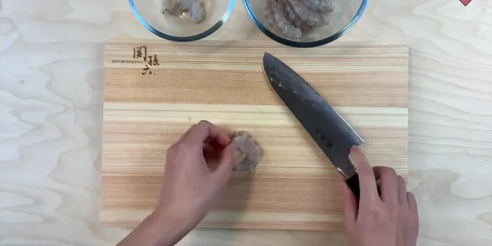 Roll out the dough into a thin sheet. (Implied by music and audio)