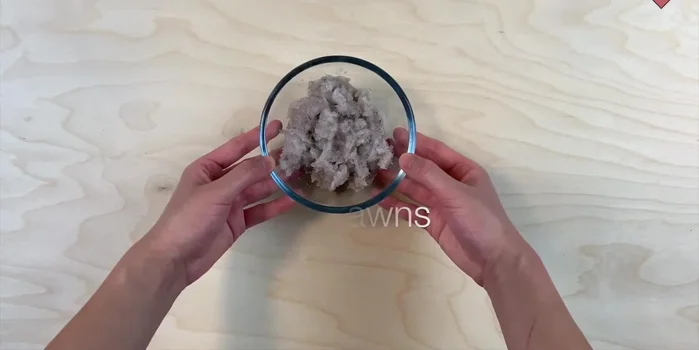 Cut the dough into small circles using a cookie cutter or a knife. (Implied by music and audio)
