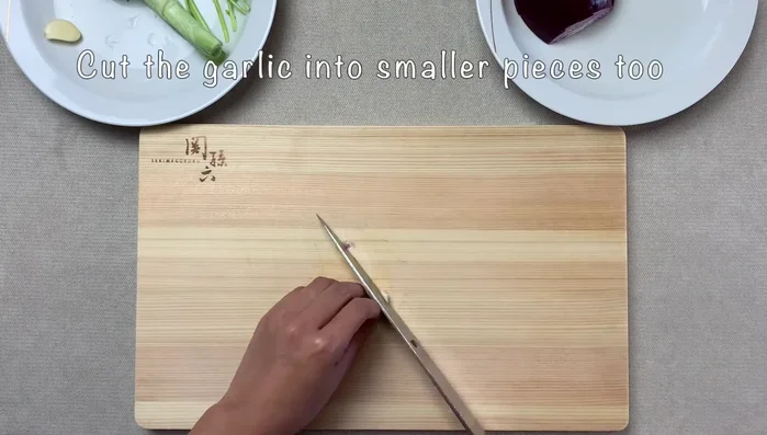 Prepare the aromatics: Julienne ginger and scallions.