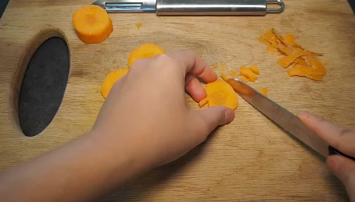 Carefully carve your desired pumpkin designs into the carrots. You can use various tools for different carving effects.