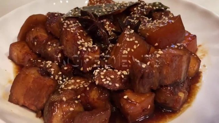 Prepare the pork belly. (Detailed instructions would be added here based on the video content, as the transcript only shows music)