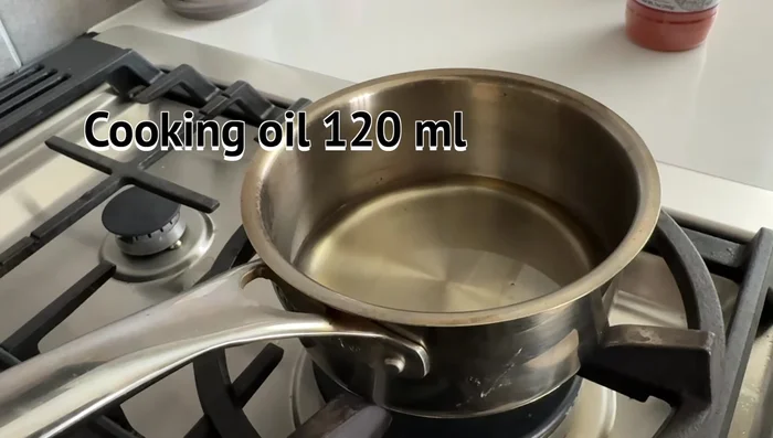 Make chili oil: Heat oil to about 100°C (212°F). Add chili flakes and Korean chili powder. Stir and let cool slightly. Transfer to a jar.