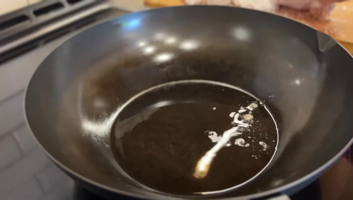 Heat oil in a wok or non-stick pan. Pan-fry pork chops until golden brown on both sides.
