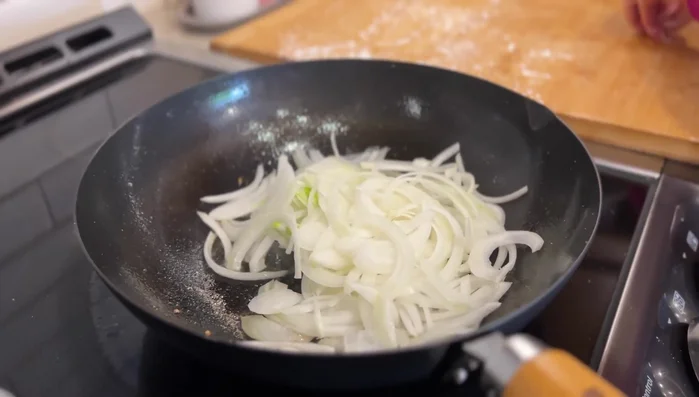 Using the residual oil, sauté the sliced onions until translucent and slightly browned (about 5 minutes).