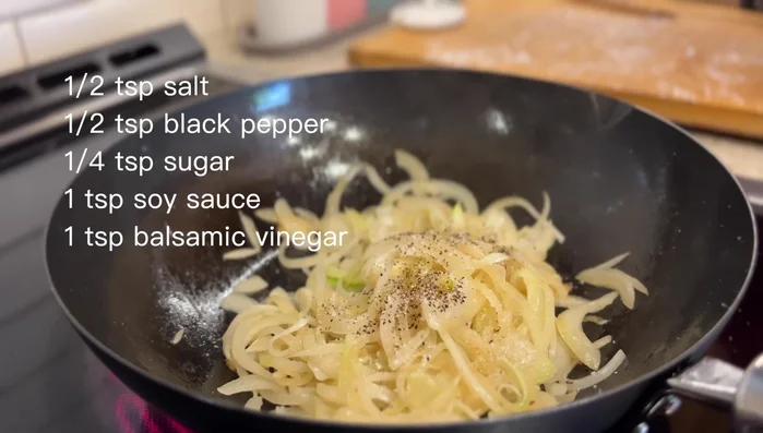 Season the onions with salt, pepper, sugar, soy sauce, and vinegar.