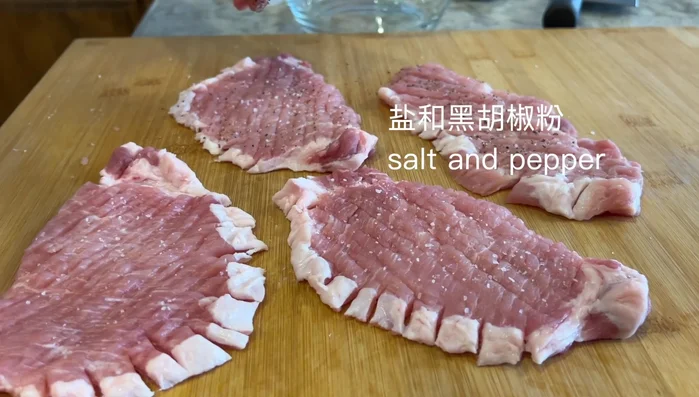 Season pork chops with salt and pepper. Marinate with rice wine, soy sauce, and oyster sauce for about 20 seconds, ensuring even distribution.
