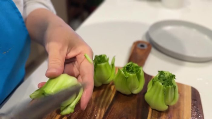 Remove the bok choy leaves, trim the edges, and flatten the base. If short on time, buy pre-cut bok choy.