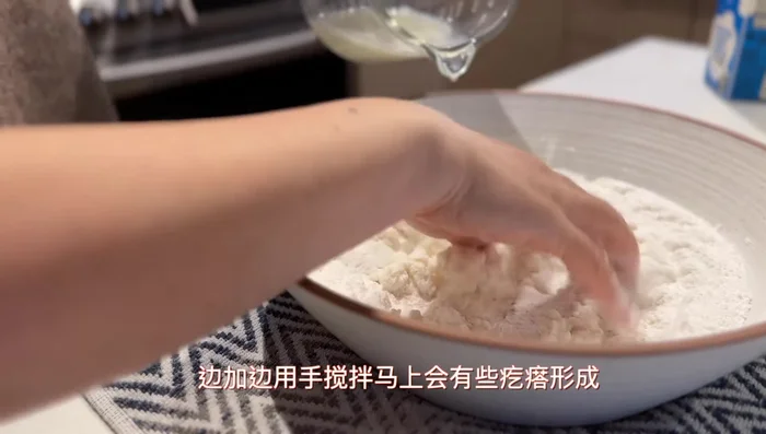 Mix the remaining dry flour into the clumps until it's a fine powder. The mixture should clump when squeezed but crumble apart when touched.