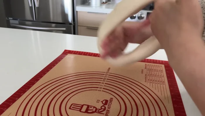Wrap the dumplings: Roll the rested dough into a long rope. Cut into even pieces (about 12g each). Prevent dough pieces from sticking together. Roll out each piece into a wrapper (slightly thicker in the center, thinner at edges). Add a heaping spoonful of filling and wrap.
