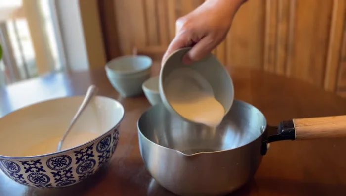 White Layer: In a separate pot, combine the remaining two parts of the coconut milk mixture with white sugar. Bring to a rolling boil and remove from heat. Add the starch mixture and stir until slightly thickened.