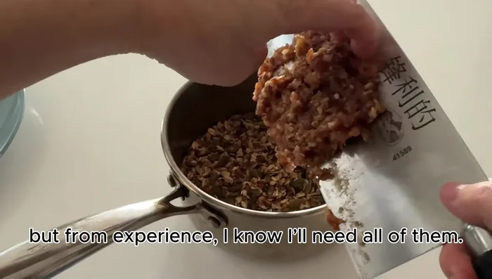 Add half of the chopped dates to the oat mixture and mix by hand, pressing the oats into the date paste.