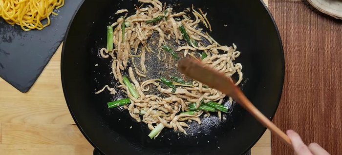Add protein to the wok and cook until browned.