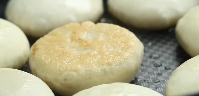 Prepare the meat filling by mixing ground meat, chopped vegetables, soy sauce, oyster sauce, sesame oil, and spices.