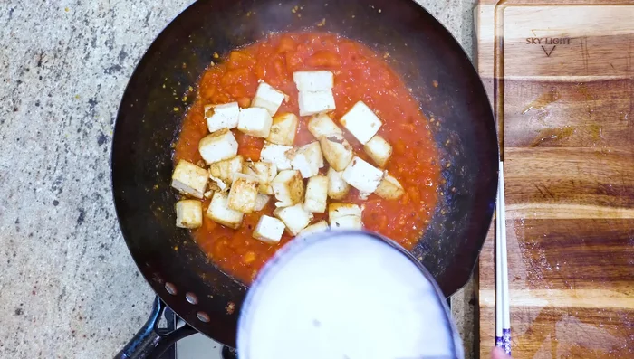 Return the tofu to the wok. Pour in chicken or vegetable stock. Bring to a boil.