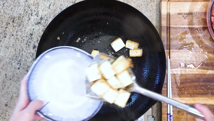 Remove tofu and set aside. Sauté garlic, ginger, and tomato paste in the remaining oil until fragrant.