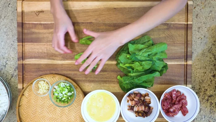 Separate the Gai Lan leaves and stems. Dice the stems and roughly chop the leaves.