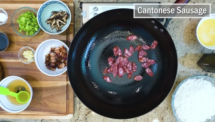 Heat the wok over medium-low heat. Add the sausage, pork belly, and mushrooms and sauté for a few minutes to release their aroma.