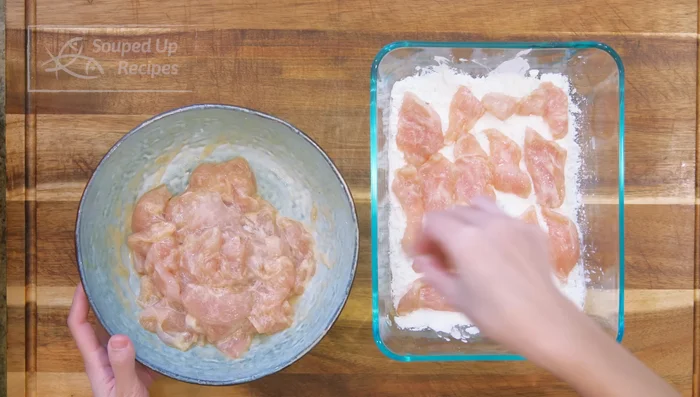Spread some cornstarch in a baking container. Add marinated chicken, sprinkle more cornstarch on top, cover, and shake well to coat.