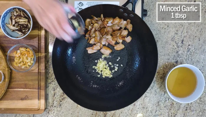 Sauté garlic, shrimp, and mushrooms in the rendered pork fat until fragrant.