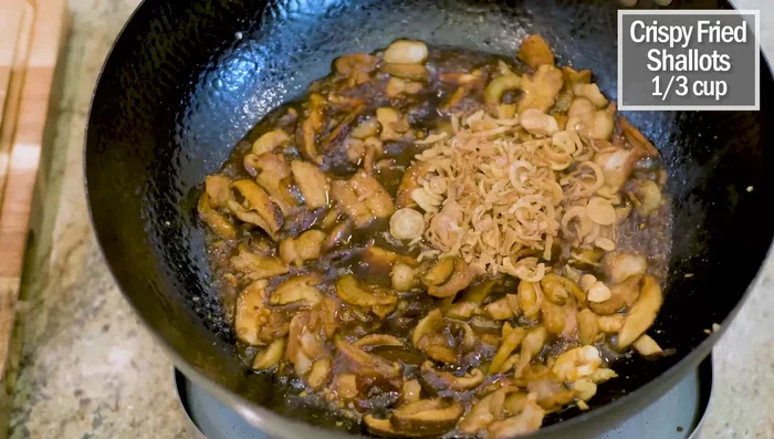 Add crispy fried shallots and stir for a minute.