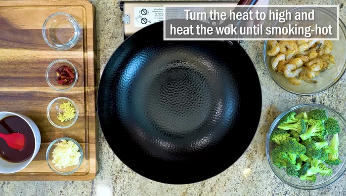 Heat wok until smoking hot. Add oil and swirl.