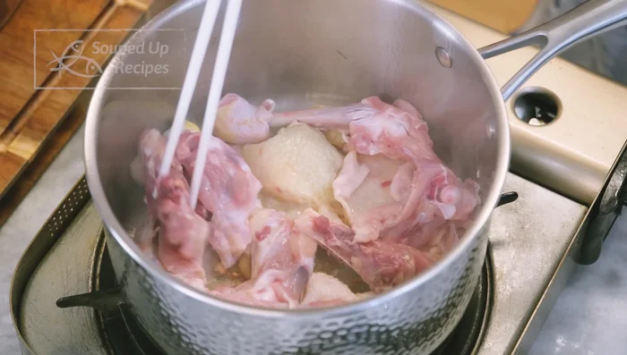 Render chicken fat, skins, and bones over medium-low heat until oil is released. Add to a pot with water/stock, scallions, shallots, ginger, and pepper; bring to a boil, then simmer while preparing other ingredients.