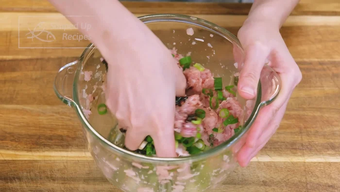 Combine the ground chicken with the cooled scallion sauce and diced scallions.
